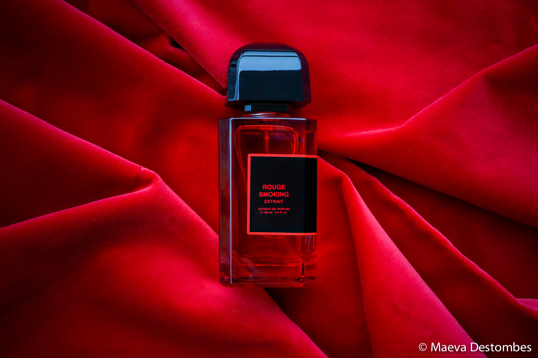 A bottle of Red Smoking Extract perfume by the perfume brand BDK on a red velvet fabric in Paris, France, November 10, 2024.<br />Une bouteille de parfum Rouge Smoking Extrait de la marque de parfumerie BDK sur un tissu de velours rouge à Paris, France, le 10 novembre 2024.