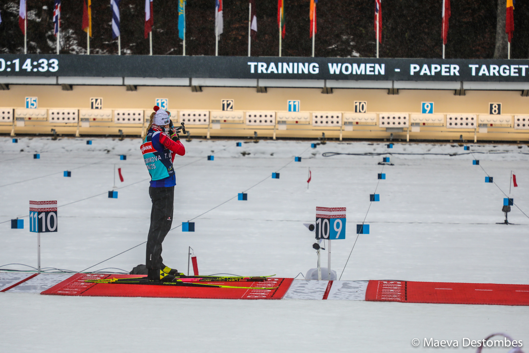 A female biathlon skier shoots a rifle at a target during the BMW IBU Biathlon World Cup at Le Grand-Bornand resort-village member of the communaute de communes des Vallees de Thones in Haute-Savoie in France on December 19 of 2024. Une skieuse de biathlon tire a la carabine sur une cible lors de la BMW IBU Coupe du monde de Biathlon au Grand-Bornand station-village membre de la communaute de communes des Vallees de Thones en Haute-Savoie en France le 19 decembre 2024.